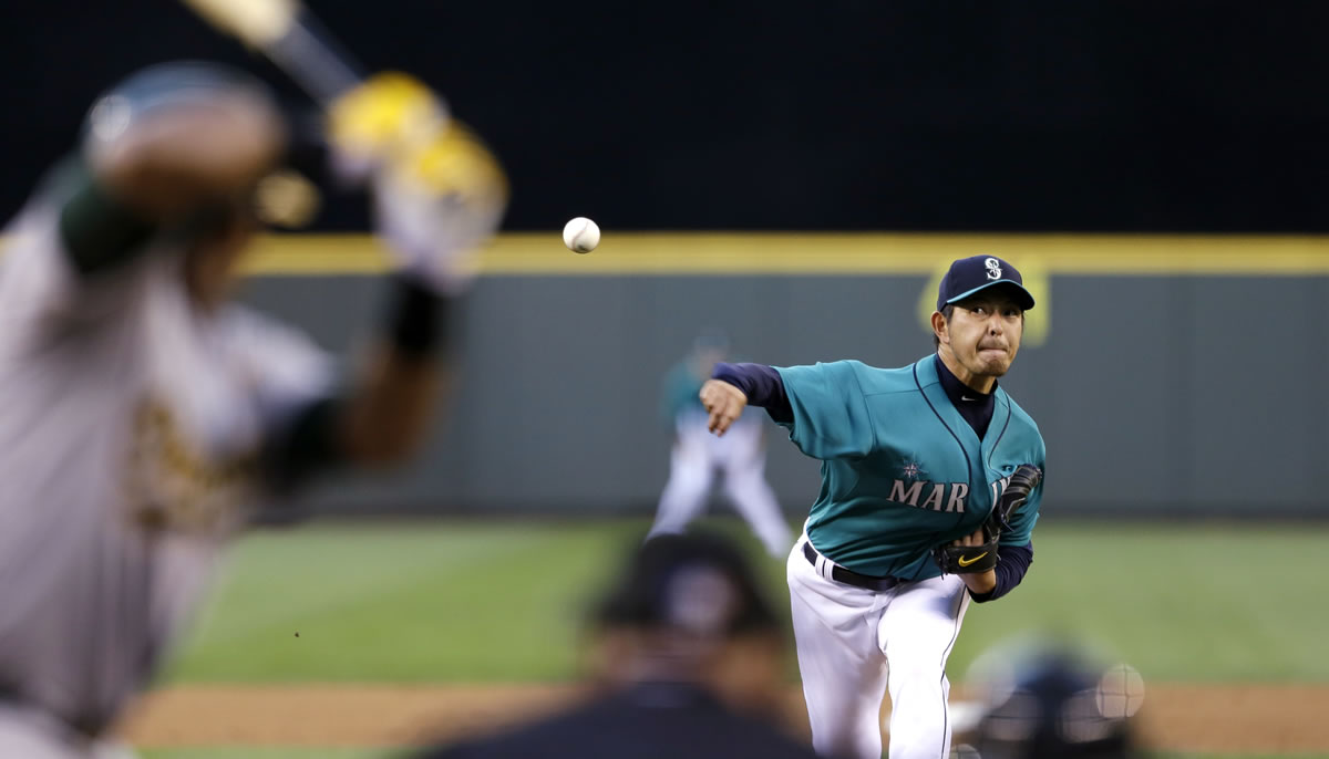 Seattle Mariners starting pitcher Hisashi Iwakuma throws to Oakland's Yoenis Cespedes in the sixth inning Friday.
