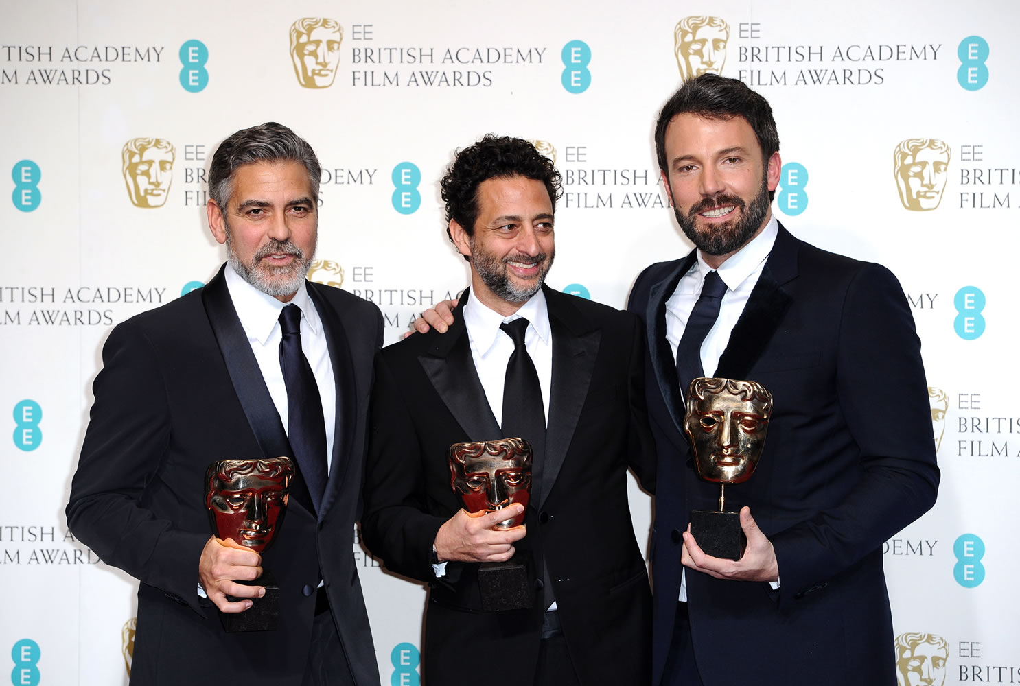 Actors George Clooney, Grant Heslov, and Ben Affleck pose with the award for Best Film, for &quot;Argo,&quot; backstage at the BAFTA Film Awards at the Royal Opera House on Sunday, in London. The film was produced by Clooney and Heslov and was directed by Affleck.
