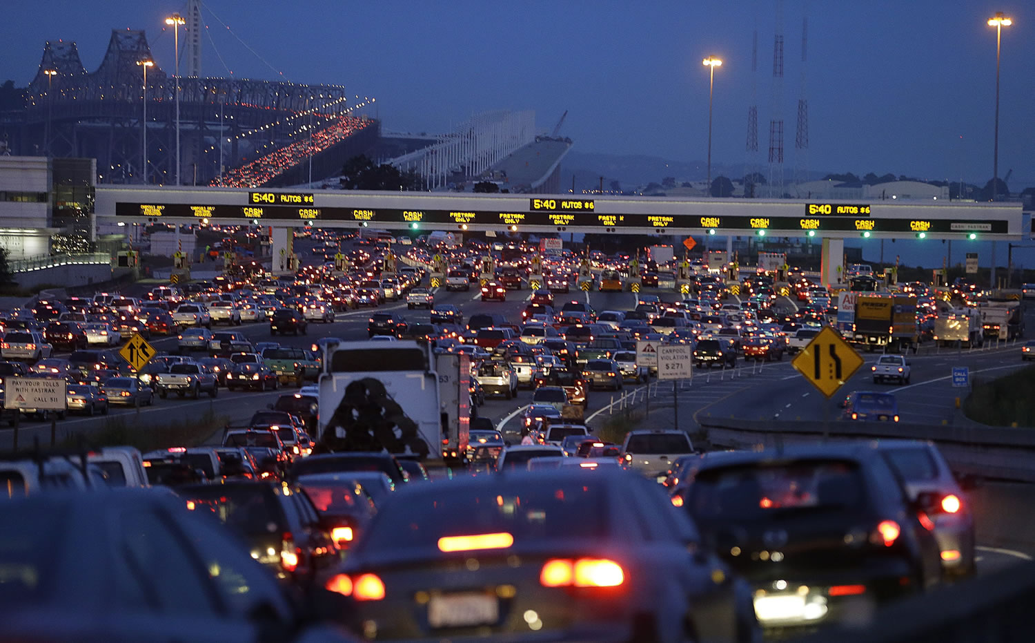 Commuters wait in standstill traffic to pay their tolls on the San Francisco-Oakland Bay Bridge in Oakland, Calif., in July.