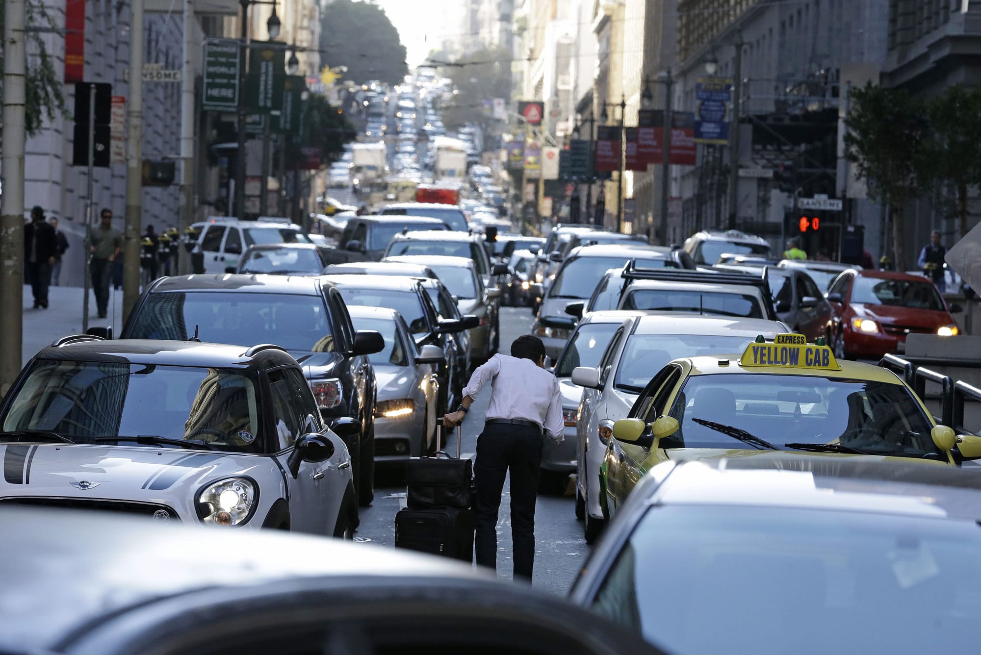 Photos by ERIC RISBERG/Associated Press
With the Bay Area Rapid Transit system on strike, traffic is backed up for blocks on Bush Street, leading to an artery of the San Francisco-Oakland Bay Bridge, during the evening commute Friday in San Francisco.