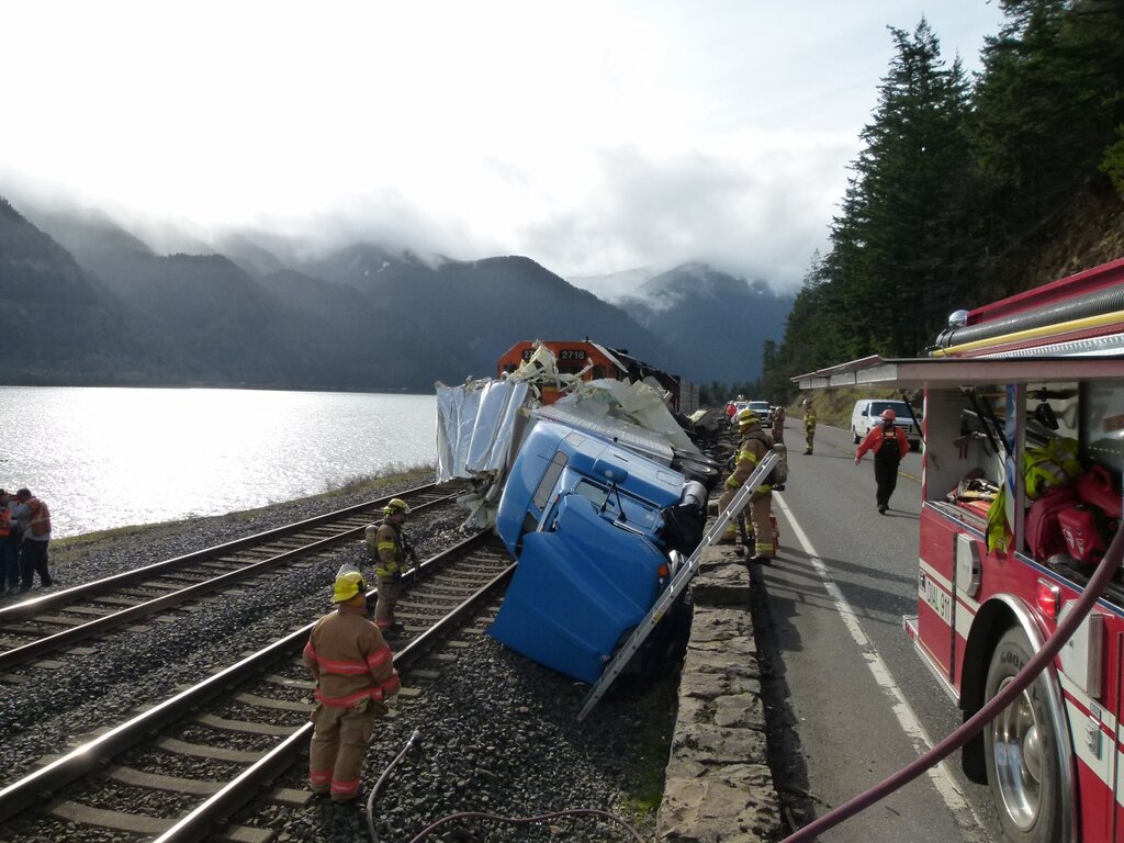 Firefighters help at the scene of a truck-train wreck in the Columbia River Gorge on Thursday afternoon.