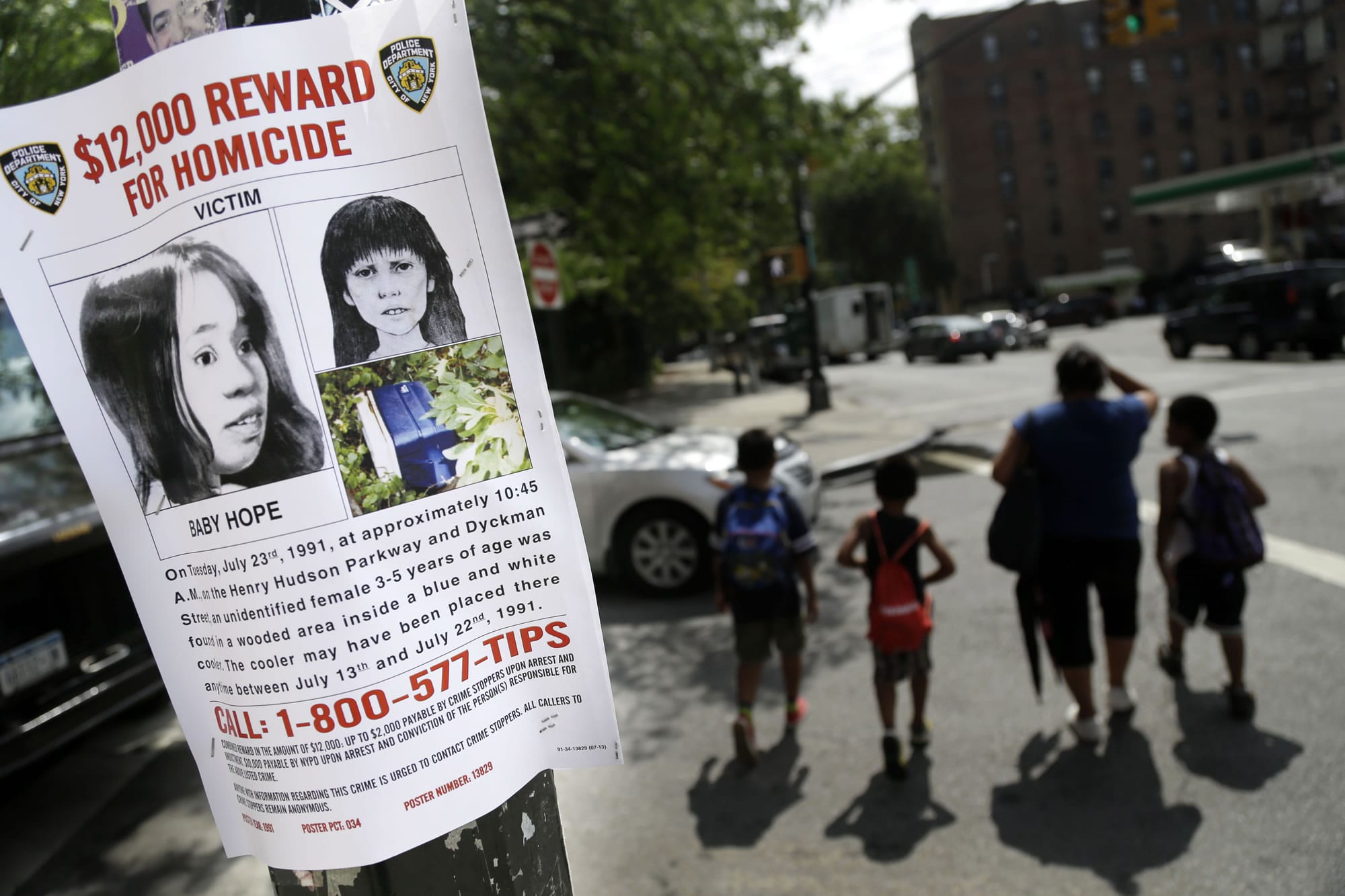 A poster soliciting information regarding an unidentified body hangs July 23 near the site where the body was found in New York.