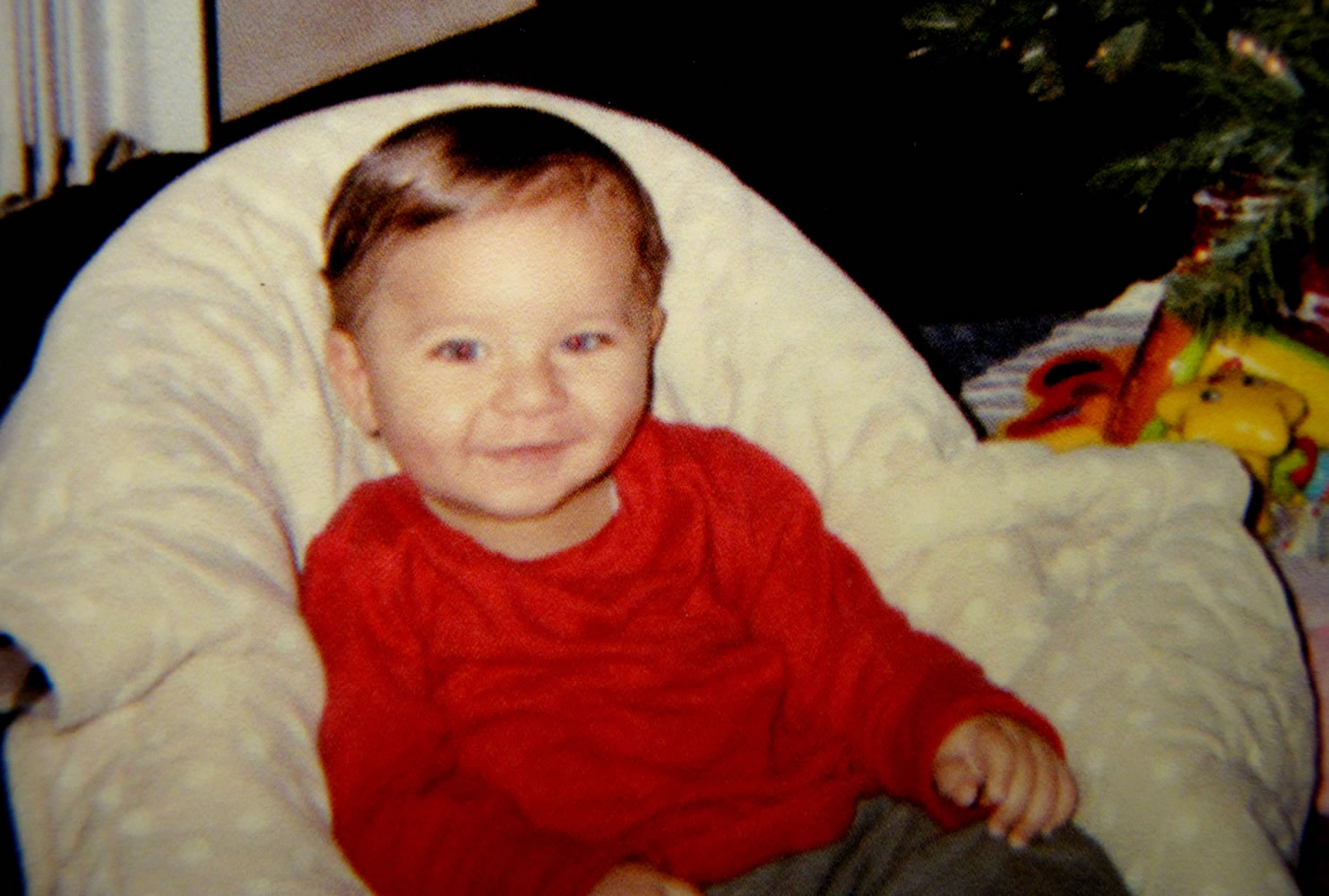 This photo provided Friday by Sherry West, of Brunswick, Ga., shows her son Antonio Santiago celebrating his first Christmas in December of 2012. West says a teenager trying to rob her at gunpoint Thursday asked &quot;Do you want me to kill your baby?&quot; before he fatally shot 13-month-old Antonio in the head. West was walking with Antonio in his stroller near their home in coastal Brunswick.