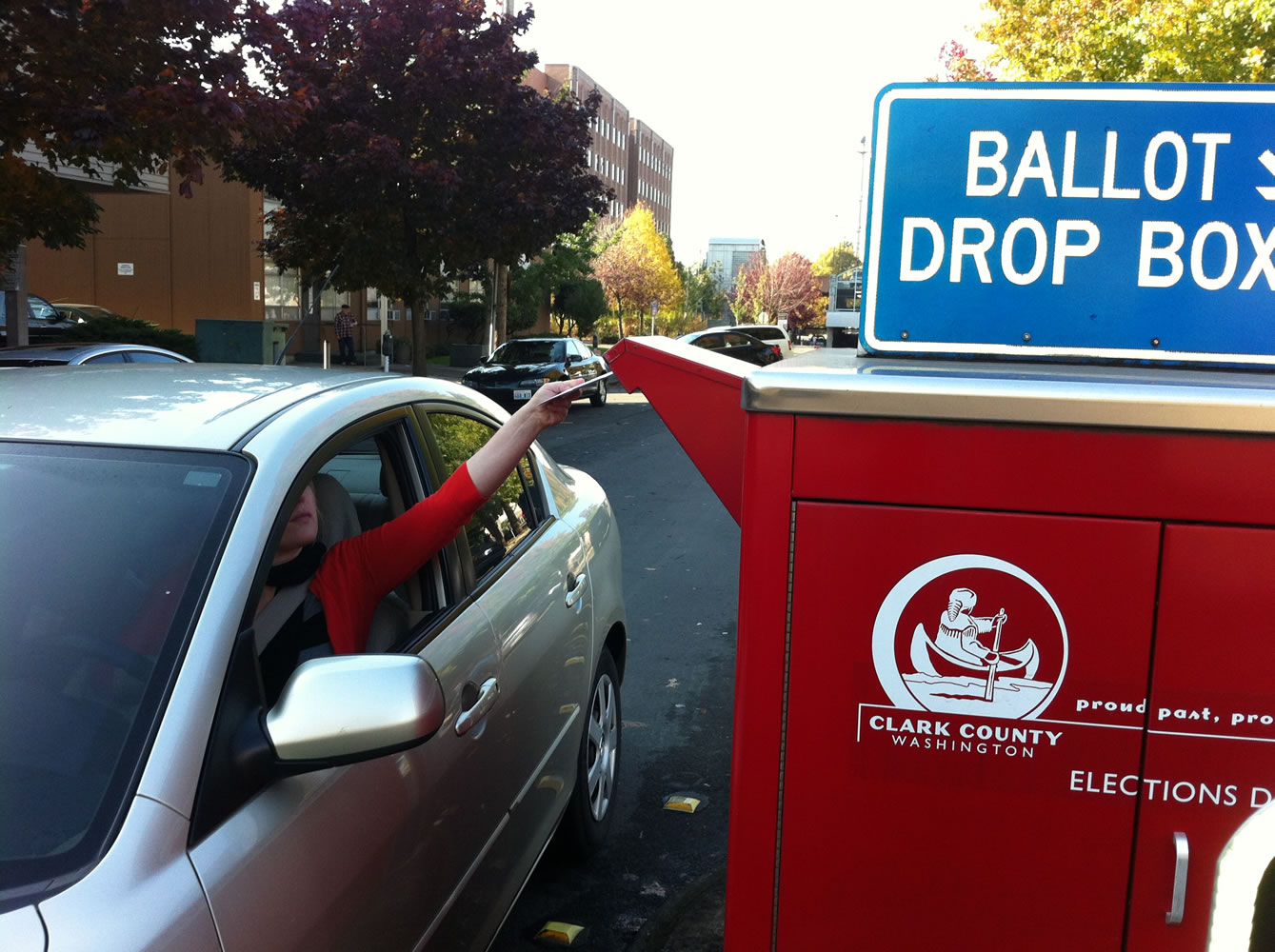 A steady stream of cars visits the ballot drop box at West 14th and Esther streets every major election.