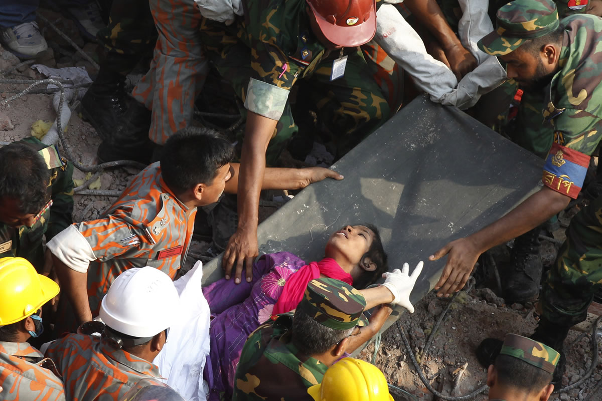 Survivor Reshma Begum lies on a stretcher Friday after being pulled from the rubble of a building that collapsed April 24 in Savar, near Dhaka, Bangladesh. Begum was working in a factory on the second floor of Rana Plaza when the building began collapsing.