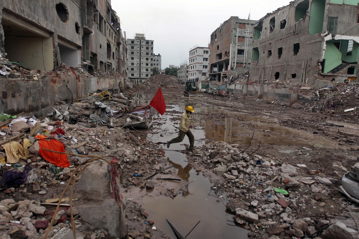 A Bangladeshi rescue worker walks at the site where a Bangladesh garment-factory building collapsed on April 24 in Savar, near Dhaka, Bangladesh.