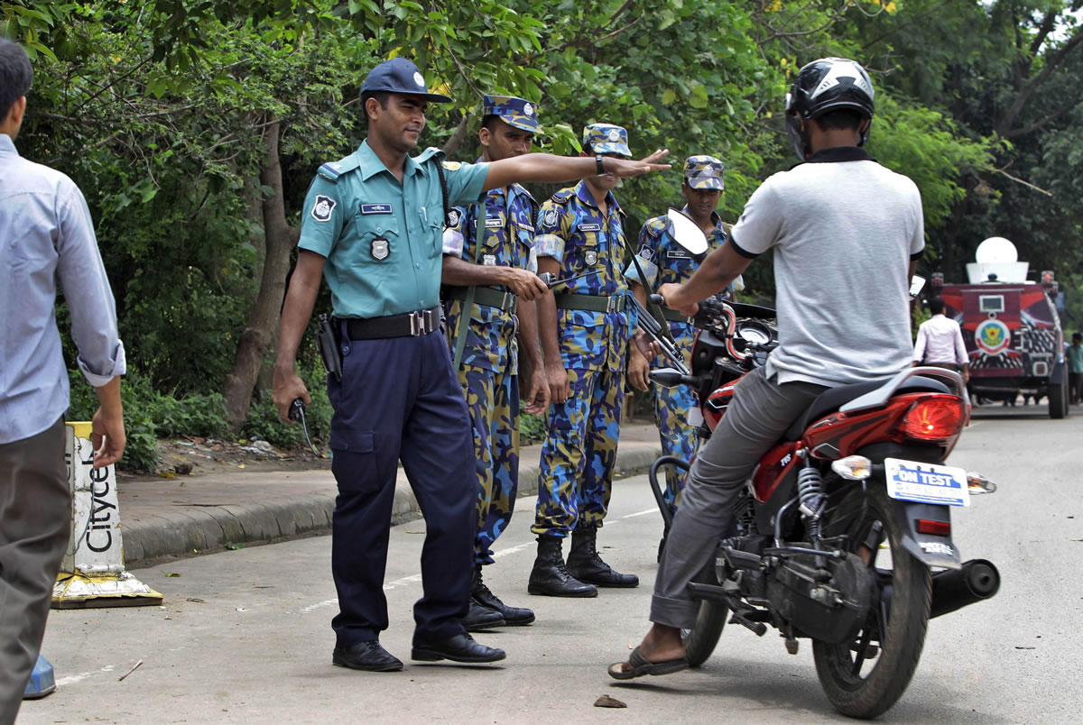 Bangladeshi police stop a motorist in front of the U.S.