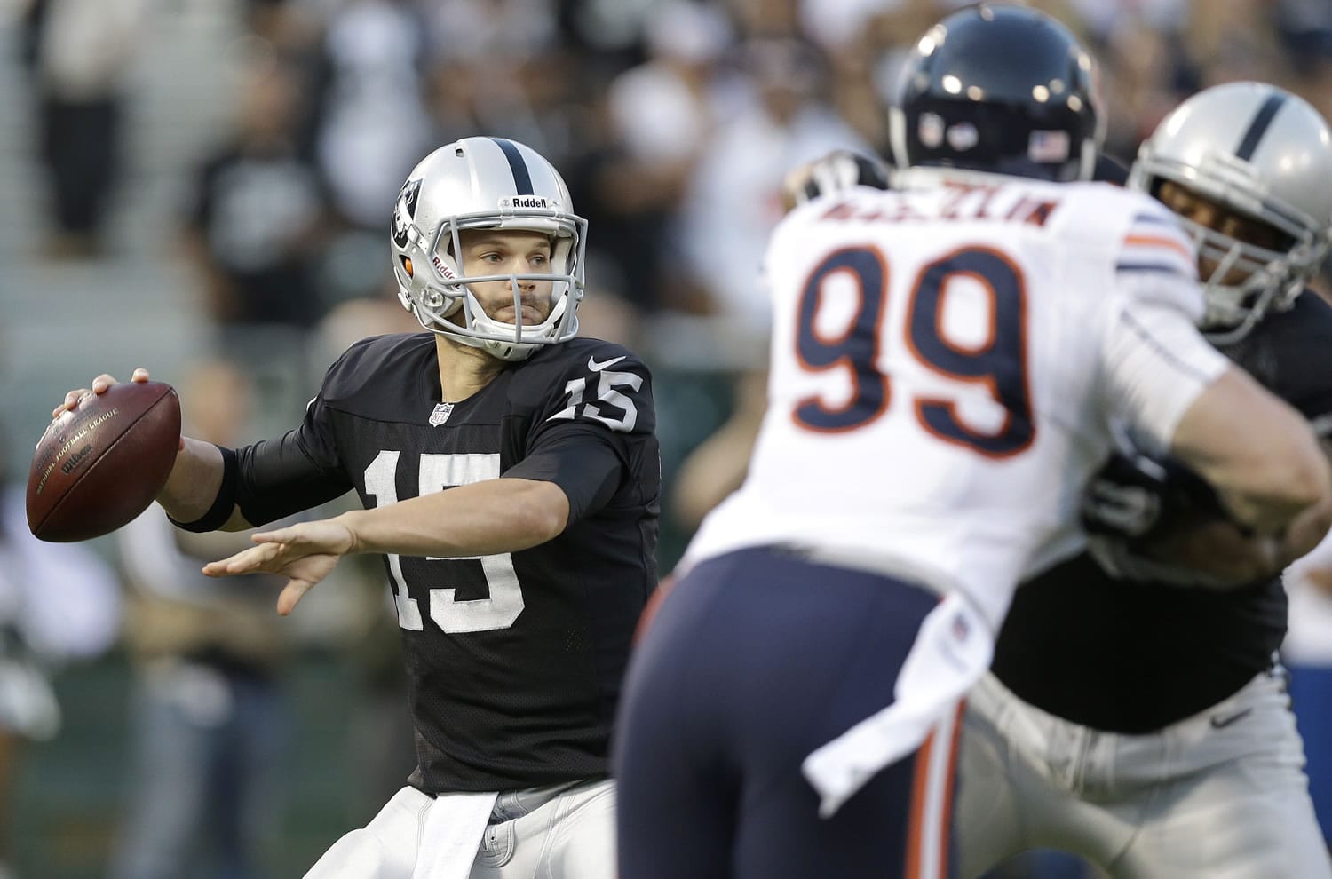 Oakland Raiders quarterback Matt Flynn (15) looks to throw as Chicago Bears defensive end Shea McClellin (99) rushes during the first quarter of an NFL preseason football game in Oakland, Calif., Friday, Aug. 23, 2013.