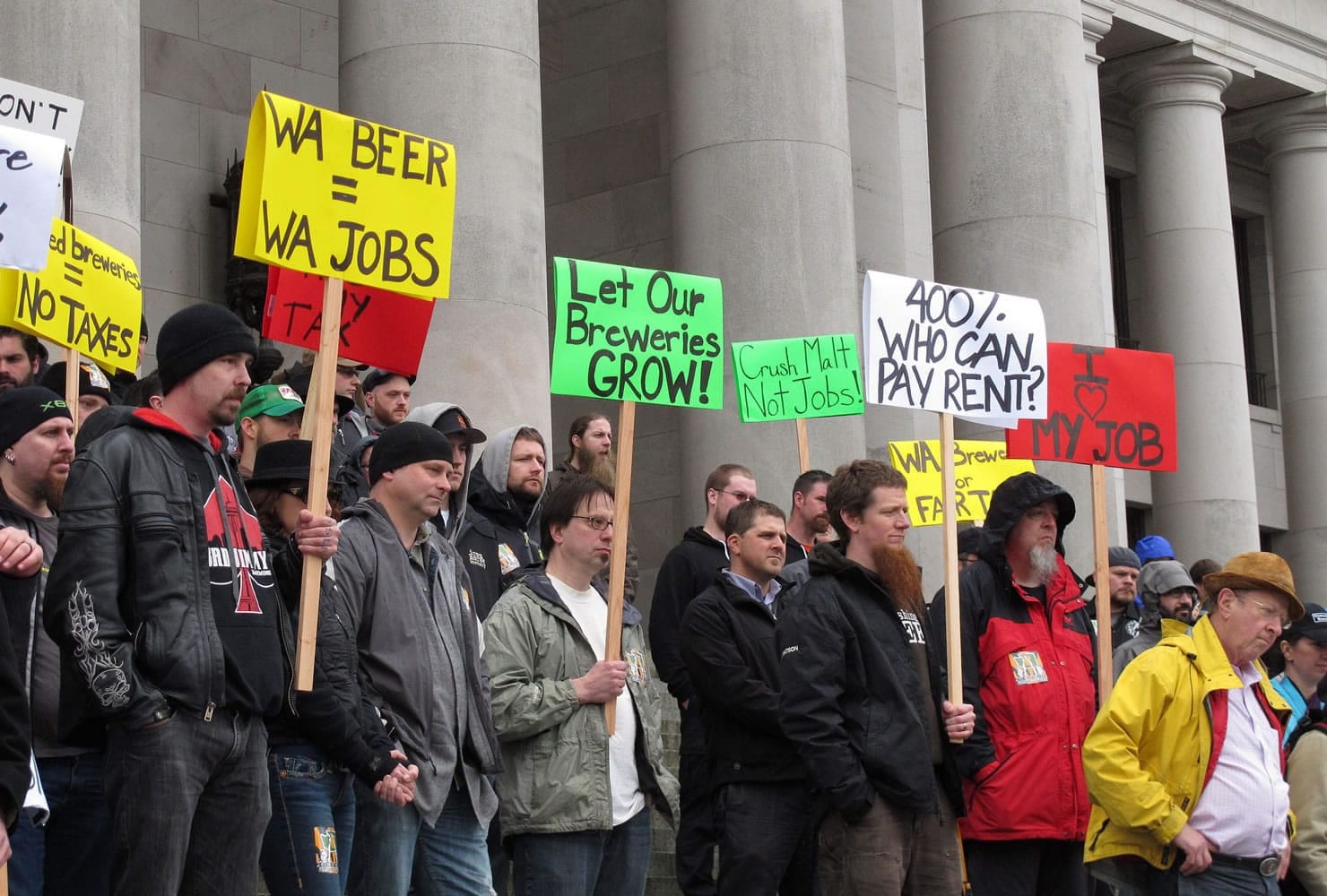 Beer brewers and others gather Friday in front of the state Capitol in Olympia to protest a proposal that would permanently extend a temporary beer tax on large brewers and would extend it to include small brewers.