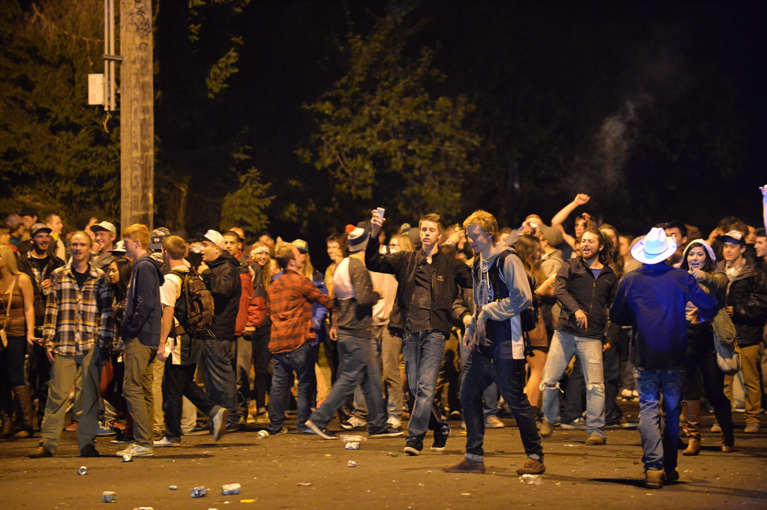 Hundreds of revelers gather in Bellingham near the Western Washington University campus after police dispersed a noisy party that had drawn a few hundred people.