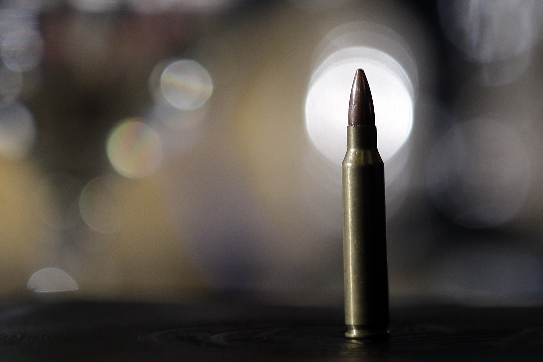 A bullet sits on a table during a discussion on gun control.