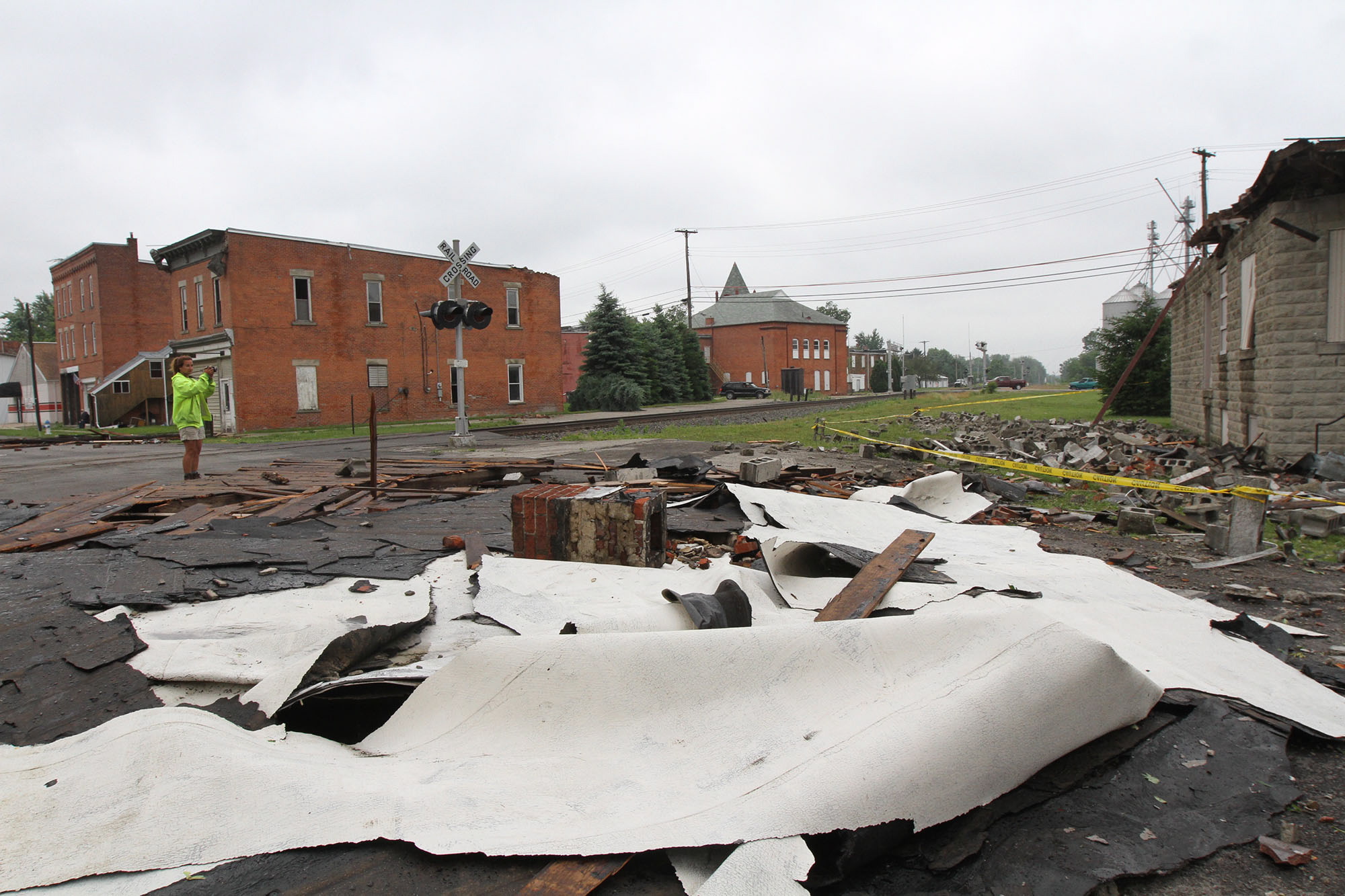 Fragments of splintered roofing lie scattered across North Water Street in Caledonia, Ohio, on Thursday.
