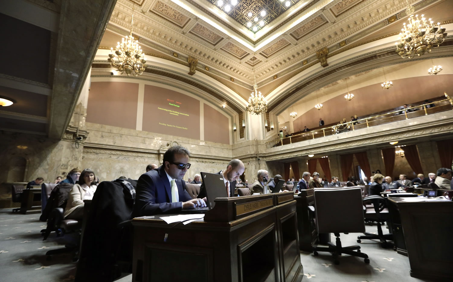 Rep. Cyrus Habib, D-Kirkland, uses his computer on the House floor during a session in Olympia. Text-to-speech software helps him to handle the massive volumes of reading required of lawmakers, allowing him to rapidly skim through even the lengthiest bills, and keep abreast of changes in their wording.