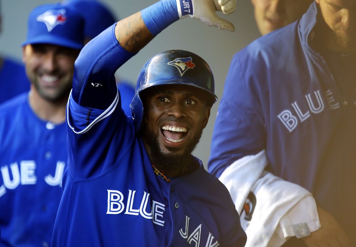Toronto's Jose Reyes celebrates in the Blue Jays dugout after he hit a solo home run off of Seattle Mariners starting pitcher Felix Hernandez in the first inning of his team's 7-2 victory at Safeco Field.