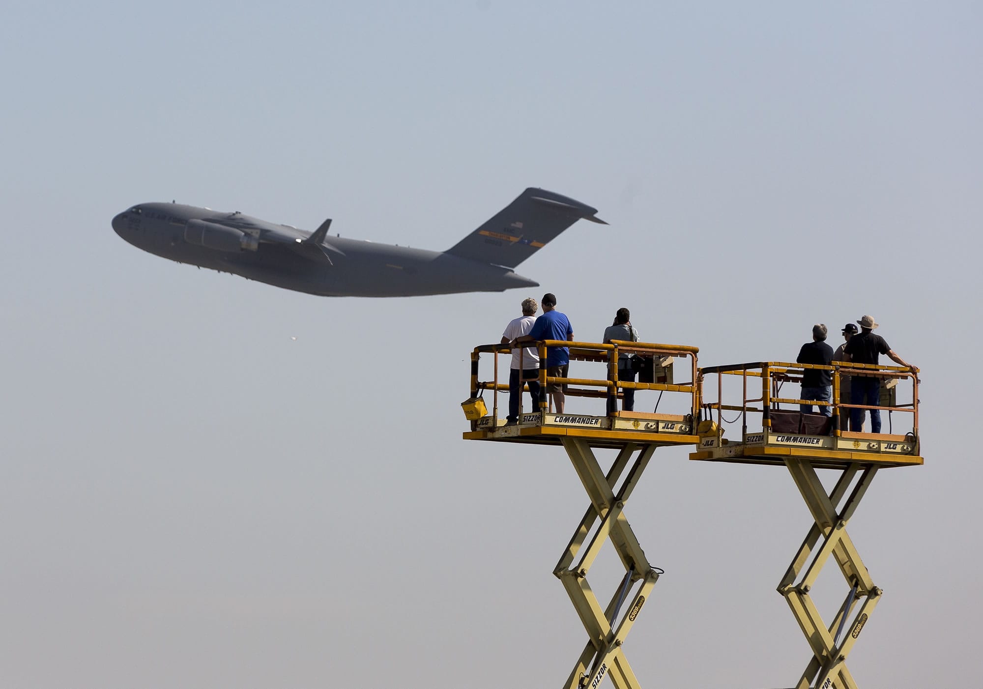 Boeing Co. workers stand on platforms as they wave at the last C-17 Globemaster III cargo jet built for the U.S.