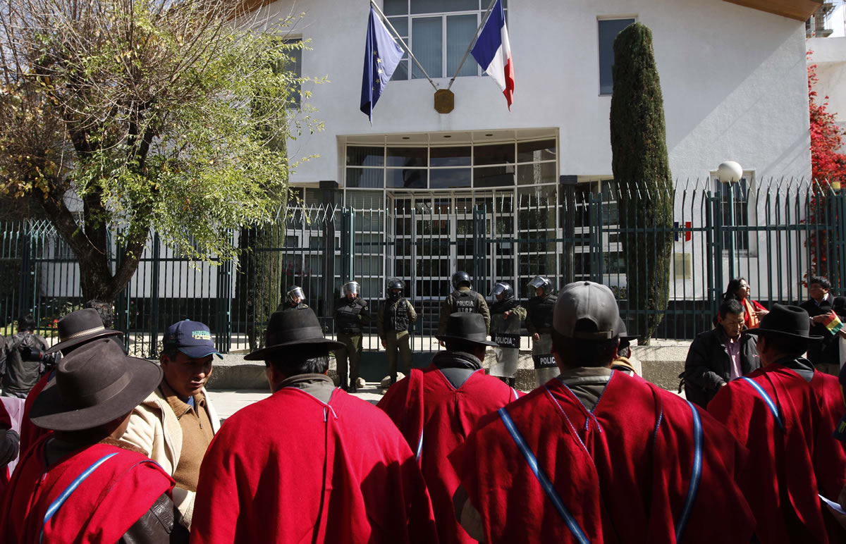 Police stand guard outside France's embassy during a protest over France's alleged refusal to let the Bolivian president's plane cross over French airspace in La Paz, Bolivia, on Wednesday.