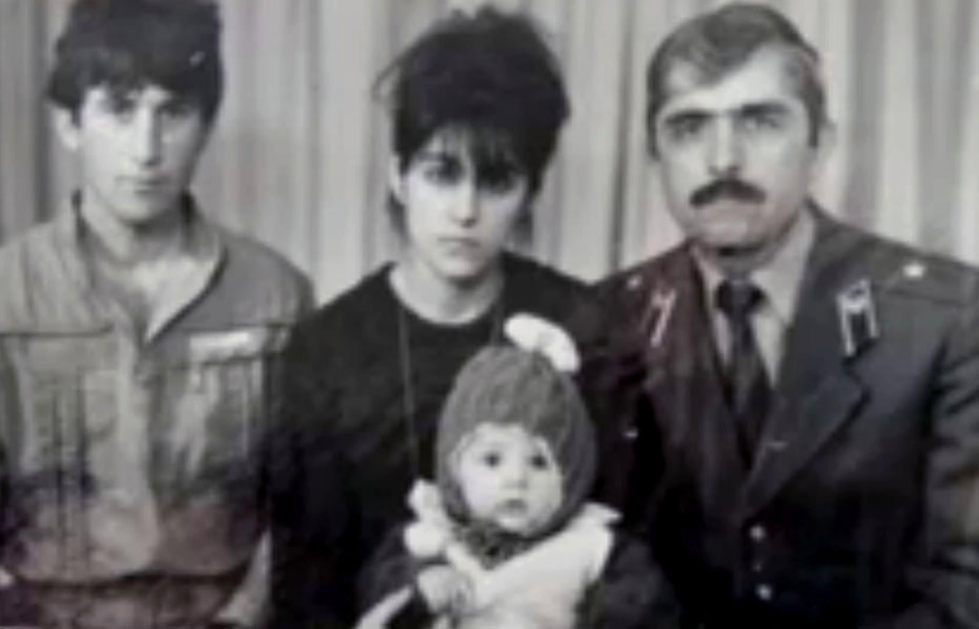 An undated family photo provided by Patimat Suleimanova, the aunt of USA Boston bomb suspects, shows Anzor Tsarnaev, left, Zubeidat Tsarnaev holding Tamerlan Tsarnaev and Anzor's brother Mukhammad Tsarnaev.