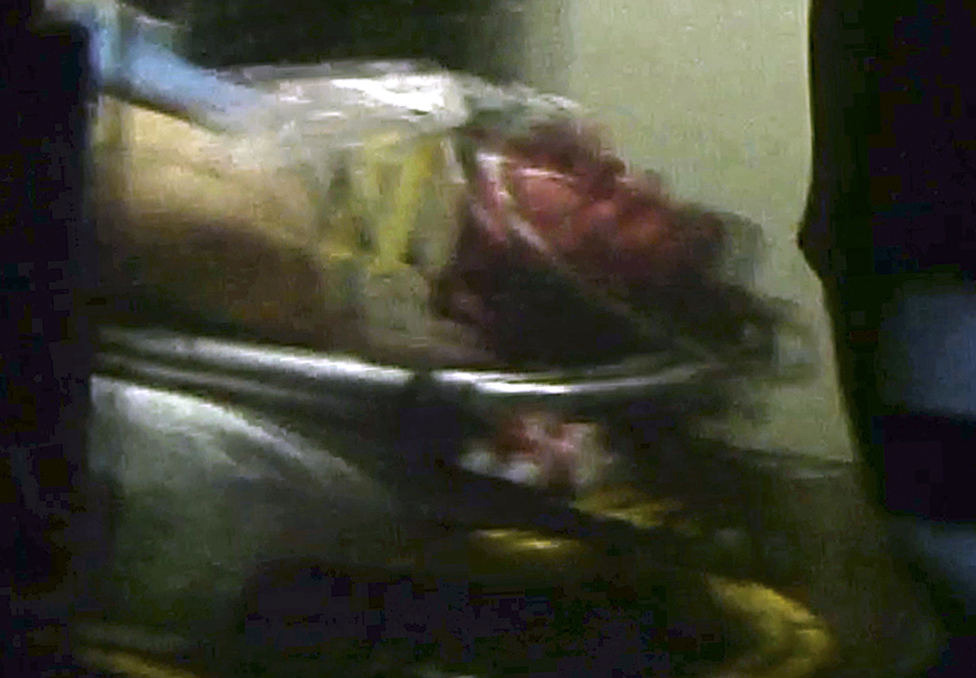This still frame from video shows Boston Marathon bombing suspect Dzhokhar Tsarnaev visible through an ambulance after he was captured in Watertown, Mass., on Friday.