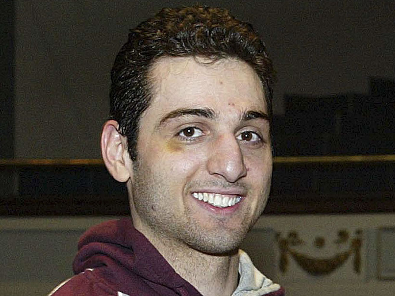 Tamerlan Tsarnaev smiles after accepting the trophy for winning the 2010 New England Golden Gloves Championship in Lowell, Mass.