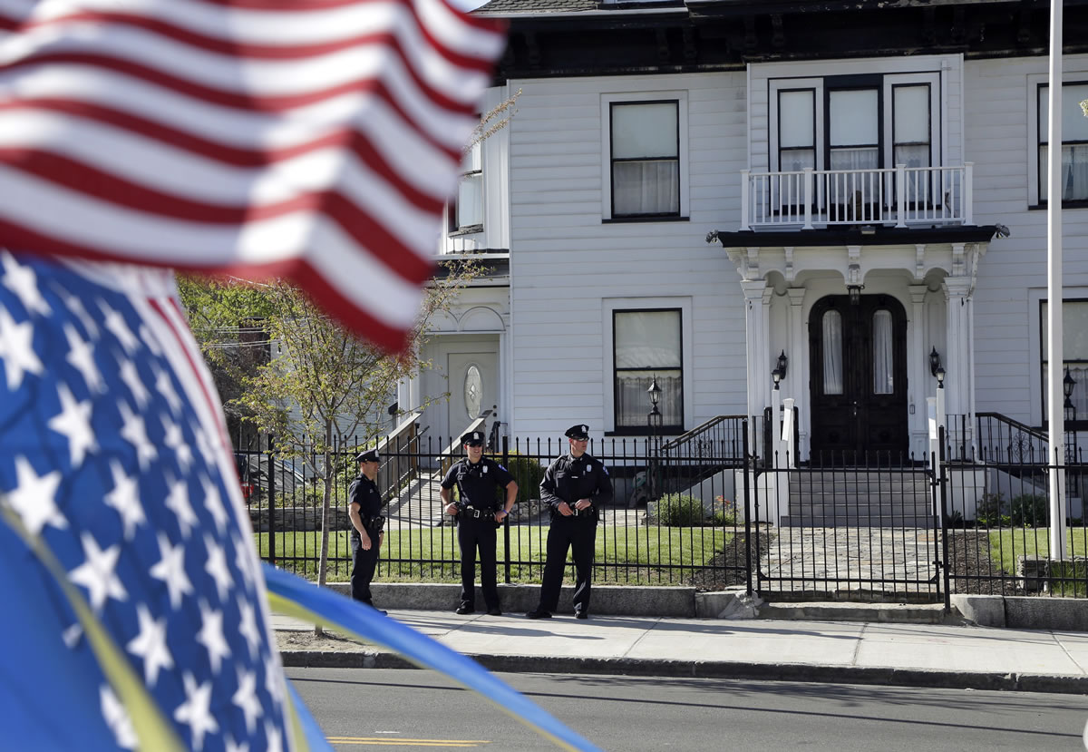 Police keep watch outside Graham, Putnam, and Mahoney Funeral Parlors in Worcester, Mass., on Monday where the body of killed Boston Marathon bombing suspect Tamerlan Tsarnaev is being prepared for burial.