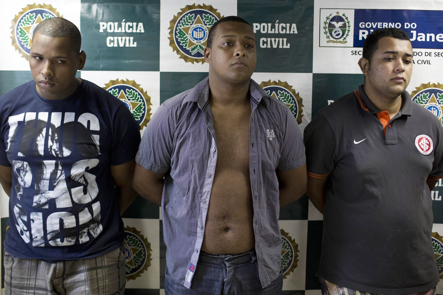 Suspects Wallace Aparecido Souza Silva, from left, Carlos Armando Costa dos Santos and Jonathan Foudakis de Souza are presented to the press at the Special Police Unit for Tourism Support after being arrested for allegedly attacking tourists in Rio de Janeiro, Brazil, on Tuesday.