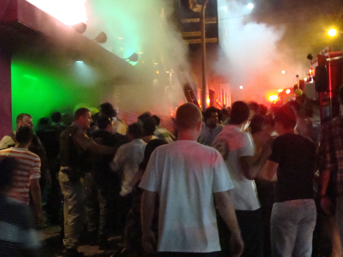 A crowd stands outside the Kiss nightclub during a fire inside the club Saturday in Santa Maria city,  Rio Grande do Sul state, Brazil.  A blaze raced through the crowded nightclub in southern Brazil early Sunday, killing 230 people as the air filled with deadly smoke and panicked party-goers stampeded toward the exits, police and witnesses said.