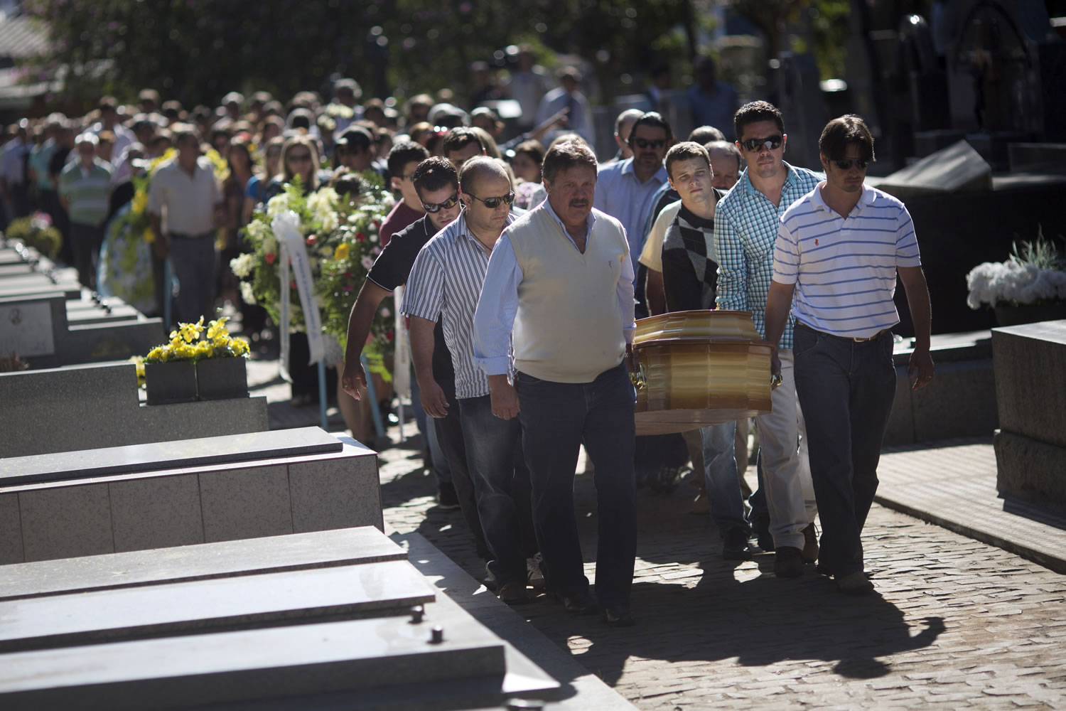 Relatives and friends carry the coffins of two brothers, Pedro and Marcelo Salla, who died in a nightclub fire, as they prepare to bury them at a cemetery in Santa Maria, Brazil, on Monday.