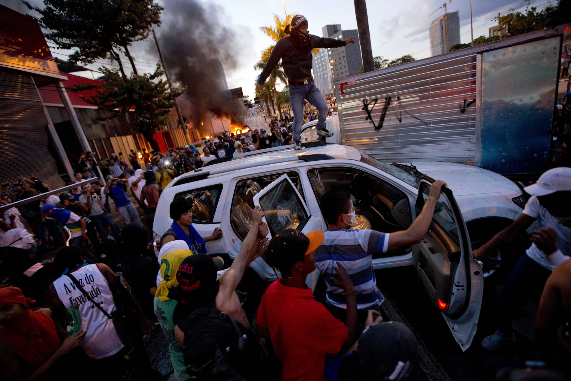 Protesters destroy a car from a car dealership June 26 during a demonstration in Belo Horizonte, Brazil.