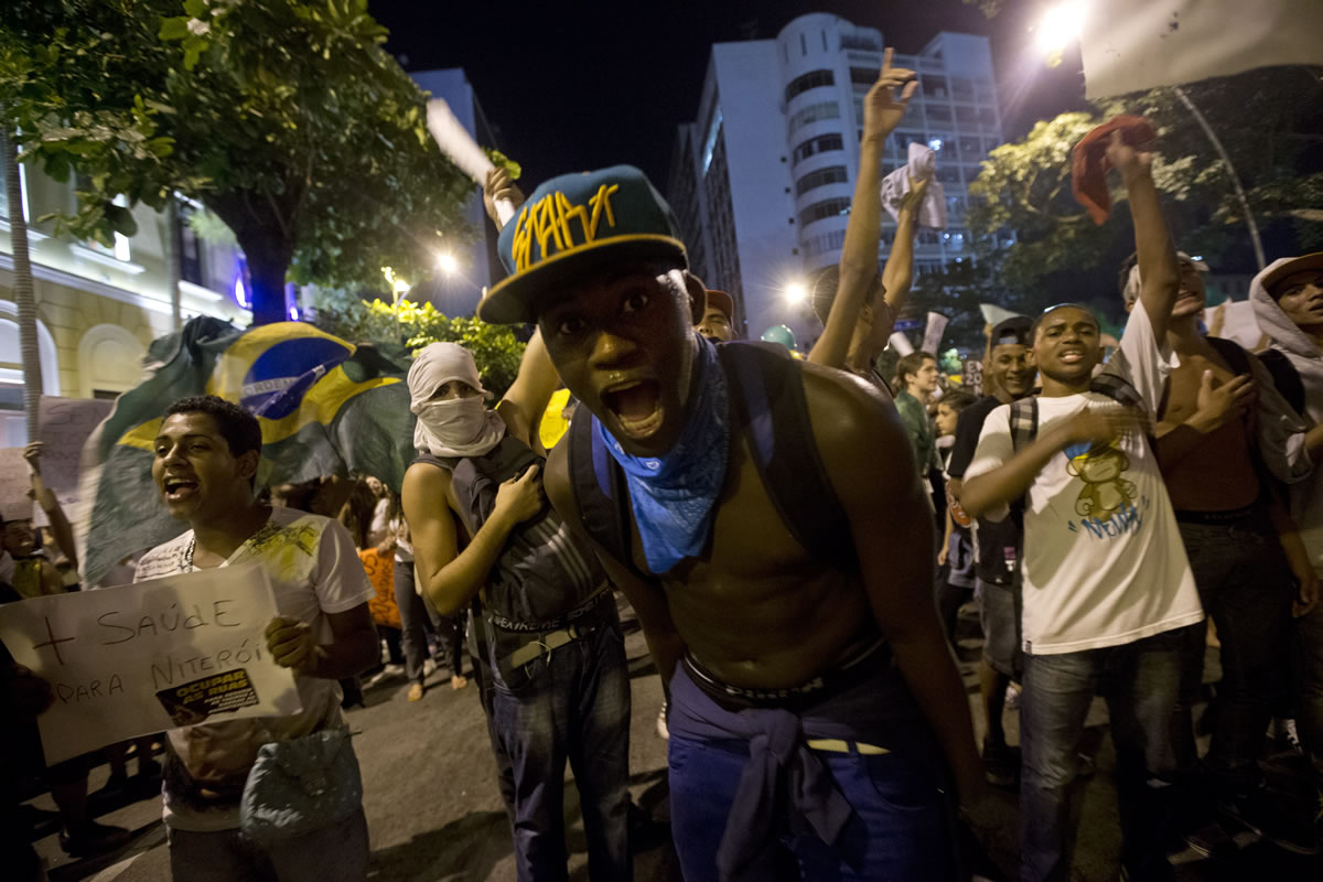 Demonstrators shout slogans during an anti-government protest in Rio de Janeiro's sister city, Niteroi, Brazil, on Wednesday evening.