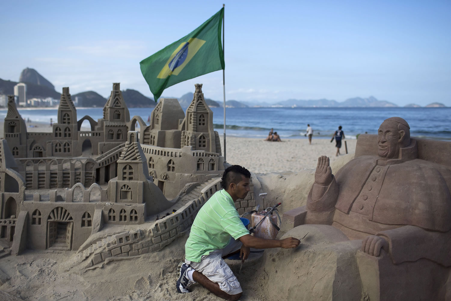 Artist Rogean Rodrigues builds a sand sculpture of Pope Francis in preparation for the pontiff's visit for World Youth Day events along Copacabana beach in Rio de Janeiro, Brazil, on Tuesday.