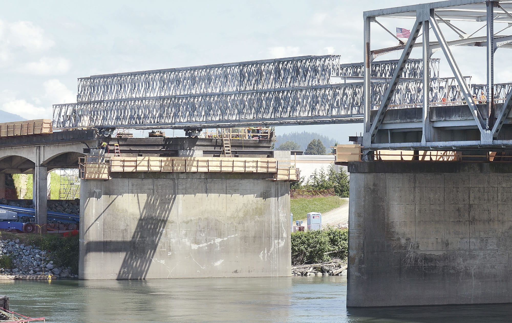 Workers install the temporary bridge extension Monday over the Skagit River on Interstate 5 on the southern end of the span.