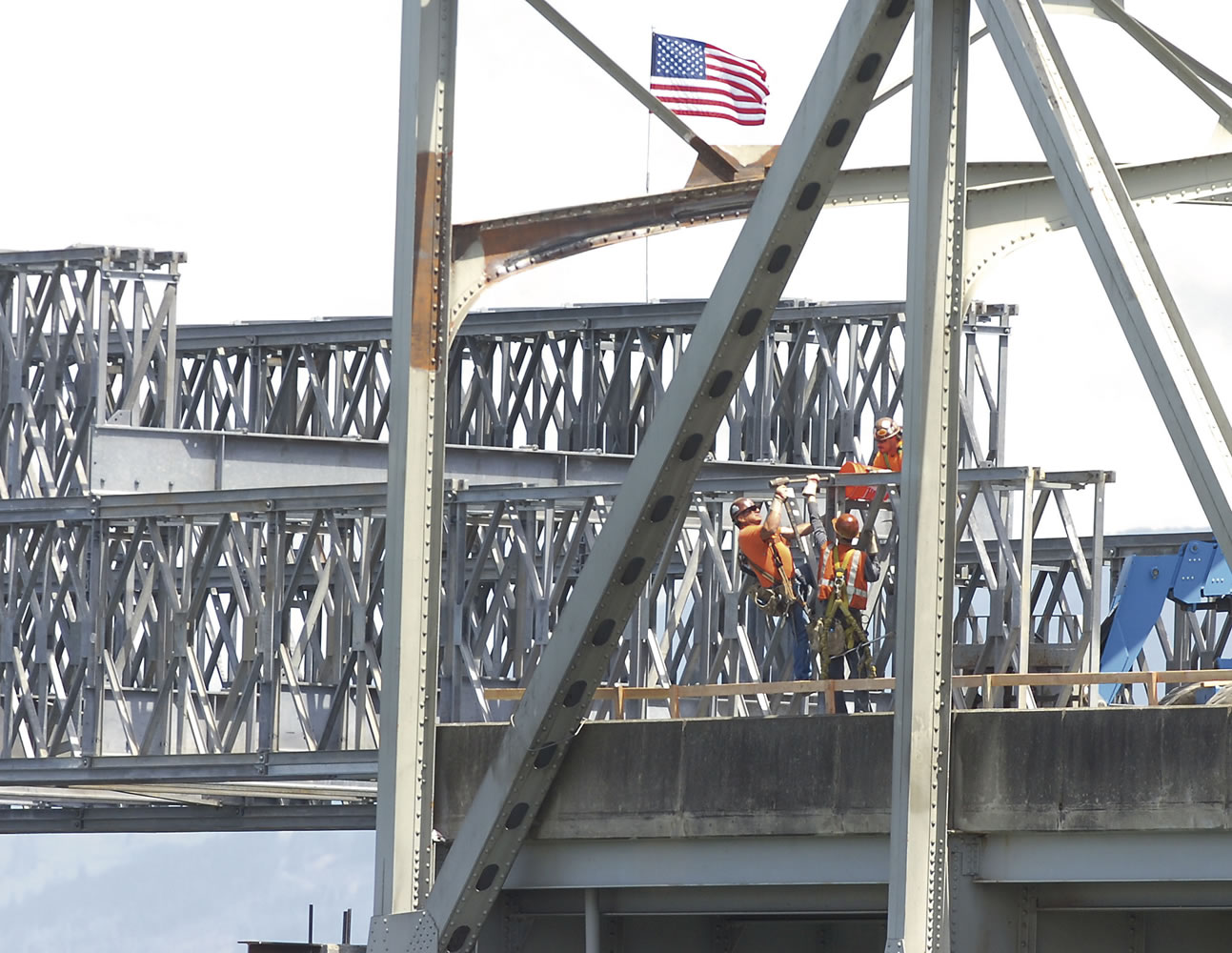 Workers disassemble the front of the temporary bridge extension Monday over the Skagit River on Interstate 5 on the southern end of the span.