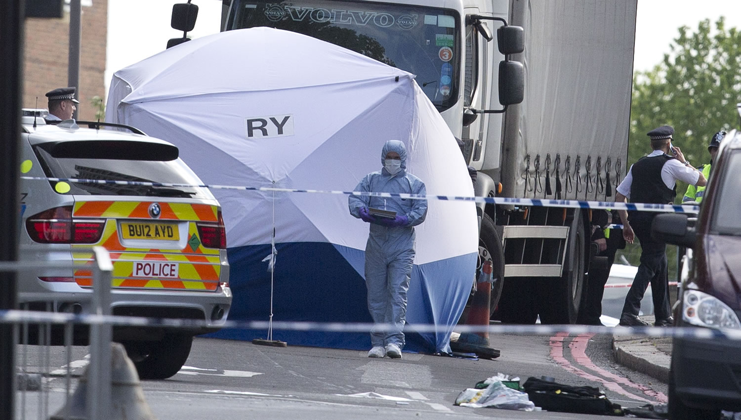 A tent is erected near the scene of an attack in Woolwich southeast London on Wednesday. A British official says a violent attack near a London barracks is being investigated as a possible terrorist act.