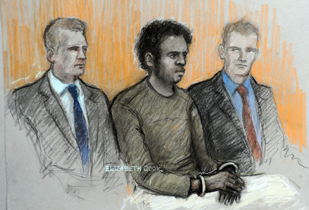 Michael Adebowale, flanked by two police officers in the dock, during his appearance at Westminster Magistratesi Court in London on Thursday where he was accused of murdering British soldier Drummer Lee Rigby on May 22.