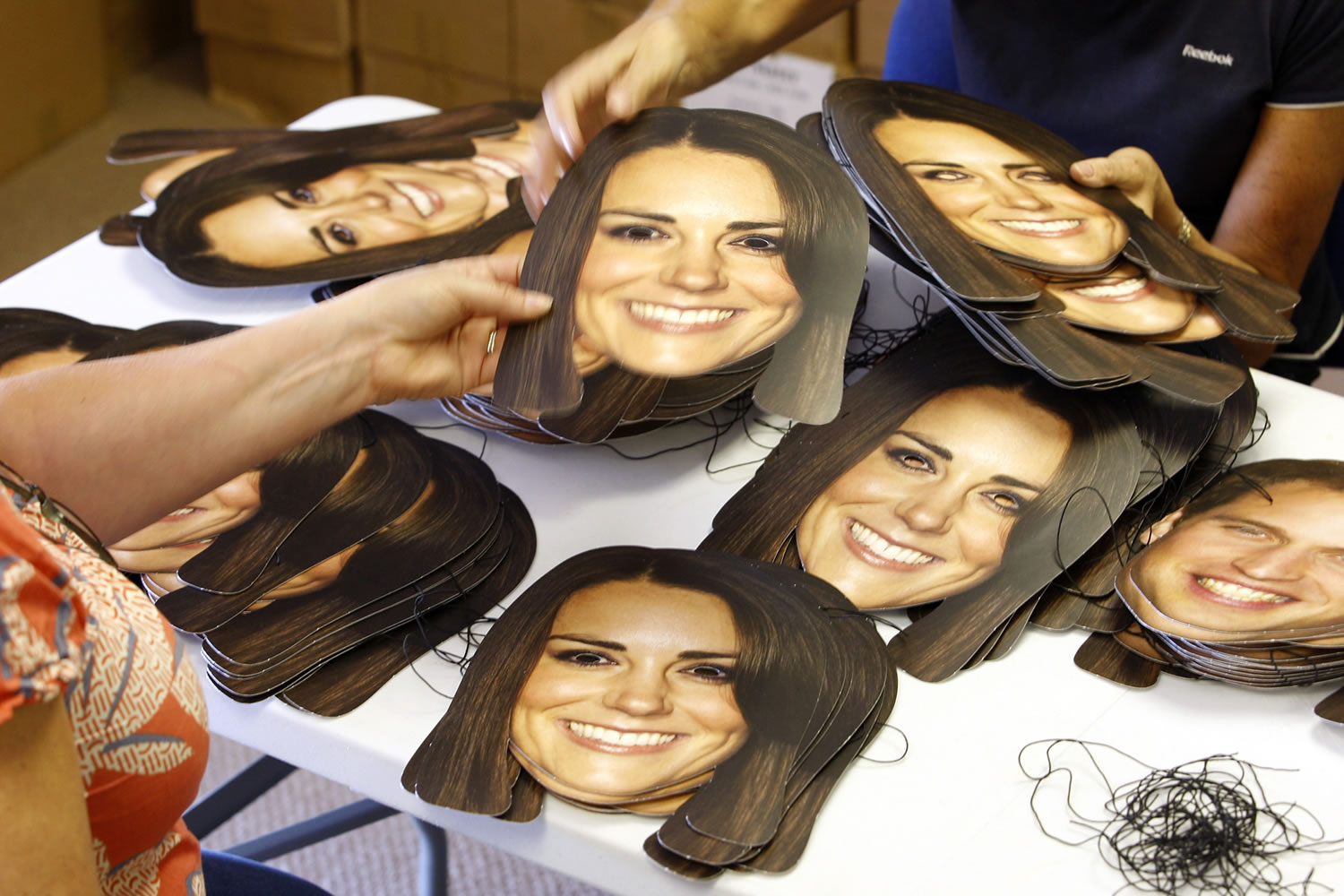 Workers from the Mask-arade mask company sort Kate, Duchess of Cambridge masks ready for dispatch June 6 at the company works in Southam, England. Mask-arade are in overdrive printing masks of Kate and William for the street parties that will follow the announcement of the birth of the Royal baby, expected in July.