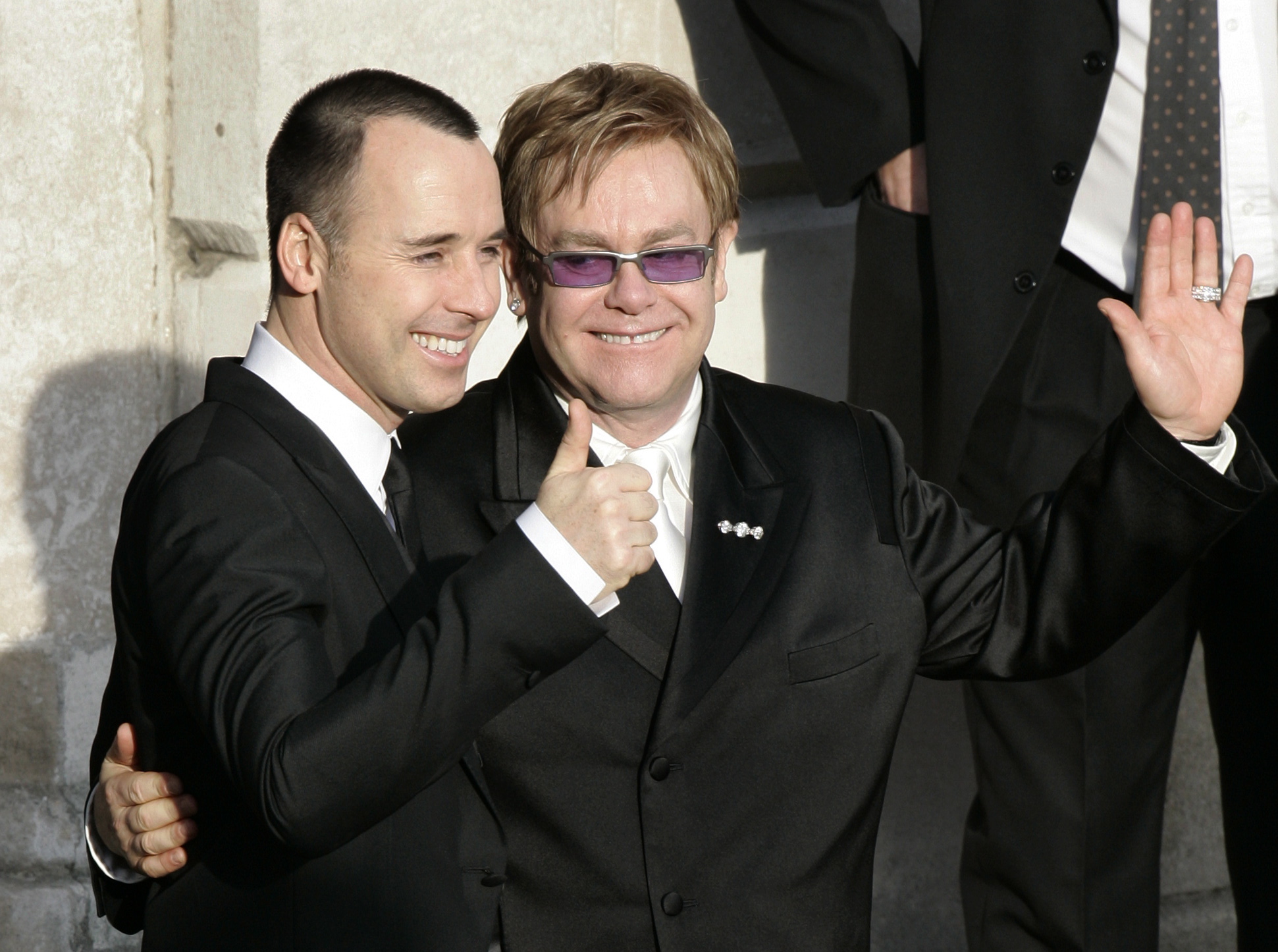Pop star Elton John, right, and his longtime partner David Furnish, embrace as they wave to members of the media and the public after they had a civil ceremony at the Guildhall in the town of Windsor, England, in 2005.