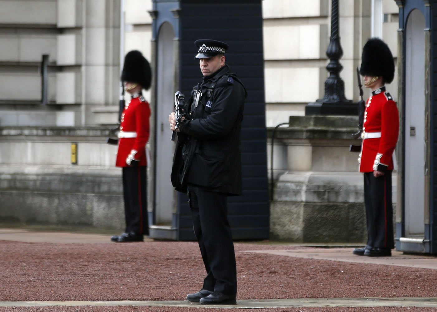 A British police officer guards the grounds of Buckingham Palace in central London on Monday.