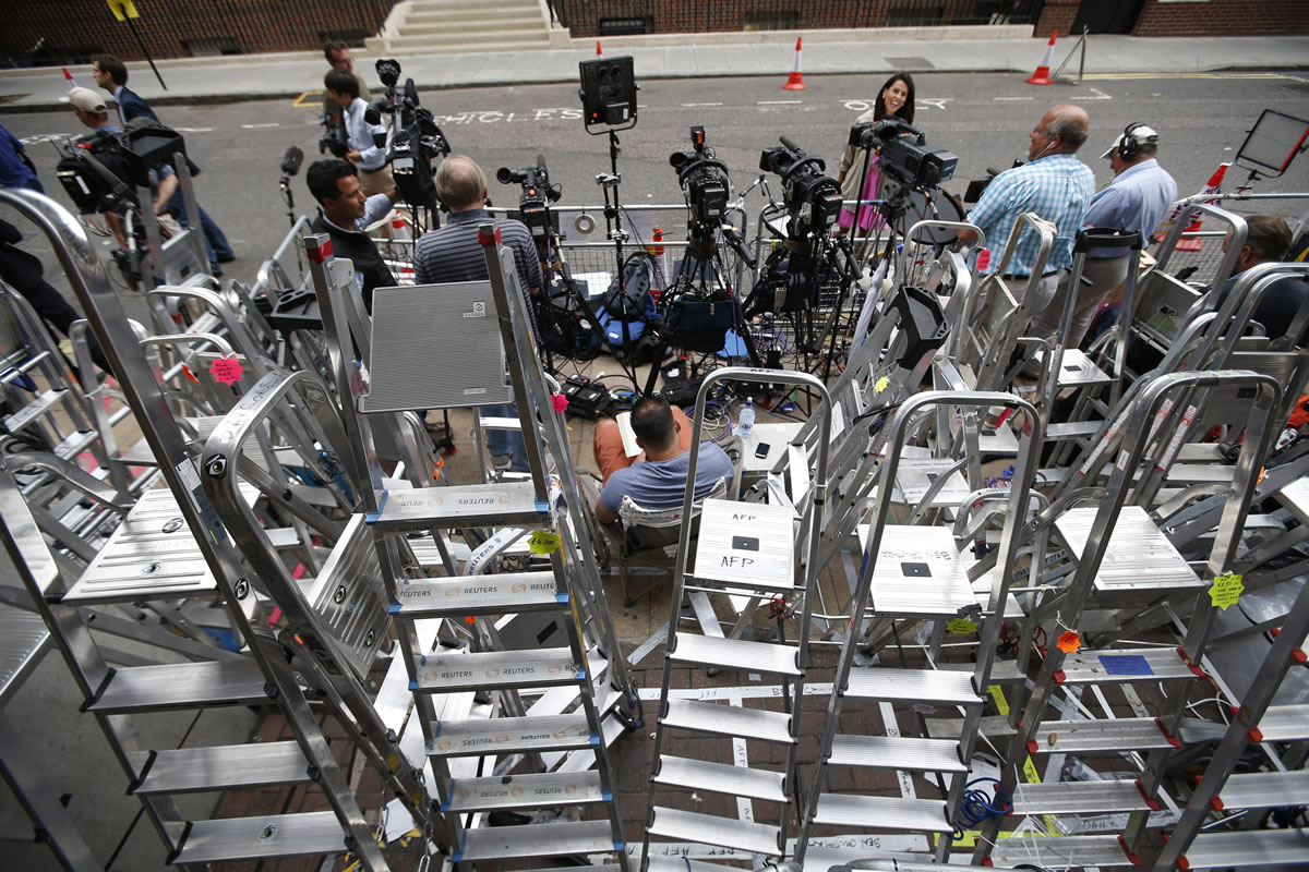 Members of the media wait next to ladders placed to ensure an elevated position for cameras Saturday across from St.