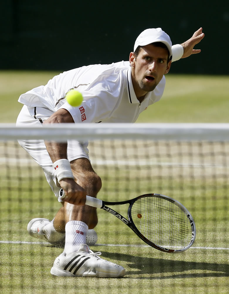 Novak Djokovic of Serbia places a drop shot in against Andy Murray of Britain during the Wimbledon men's singles final on Sunday.