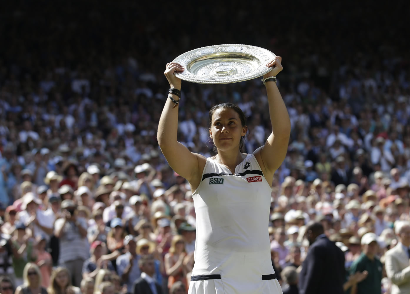 Marion Bartoli of France holds the trophy after winning the Wimbledon women's singles final over Sabine Lisicki of Germany on Saturday.