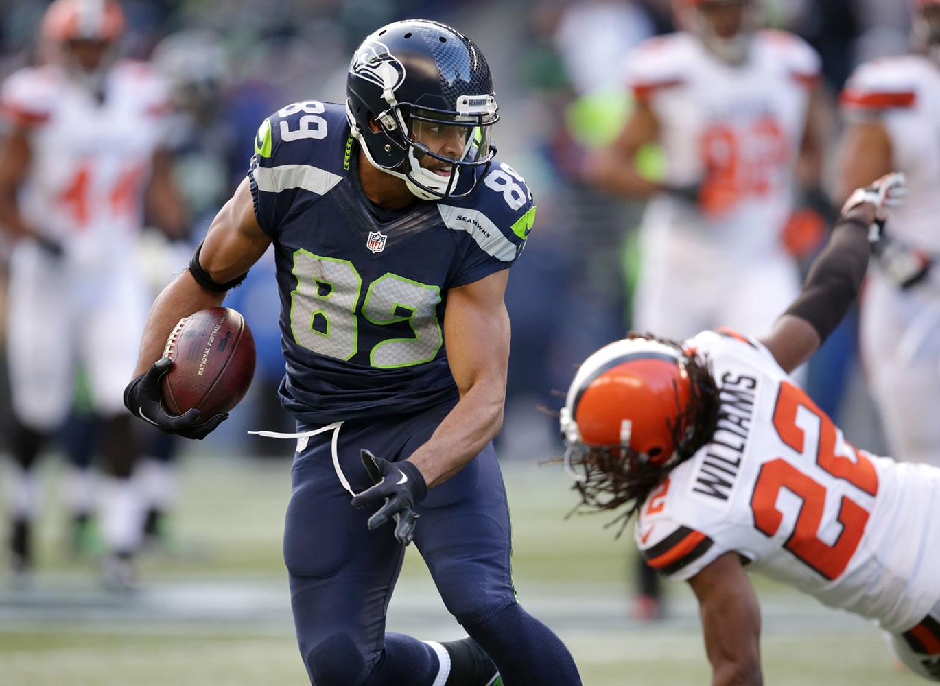 Seattle Seahawks' Doug Baldwin runs with the ball after a pass reception as Cleveland Browns' Tramon Williams falls behind in the second half of an NFL football game, Sunday, Dec. 20, 2015, in Seattle.