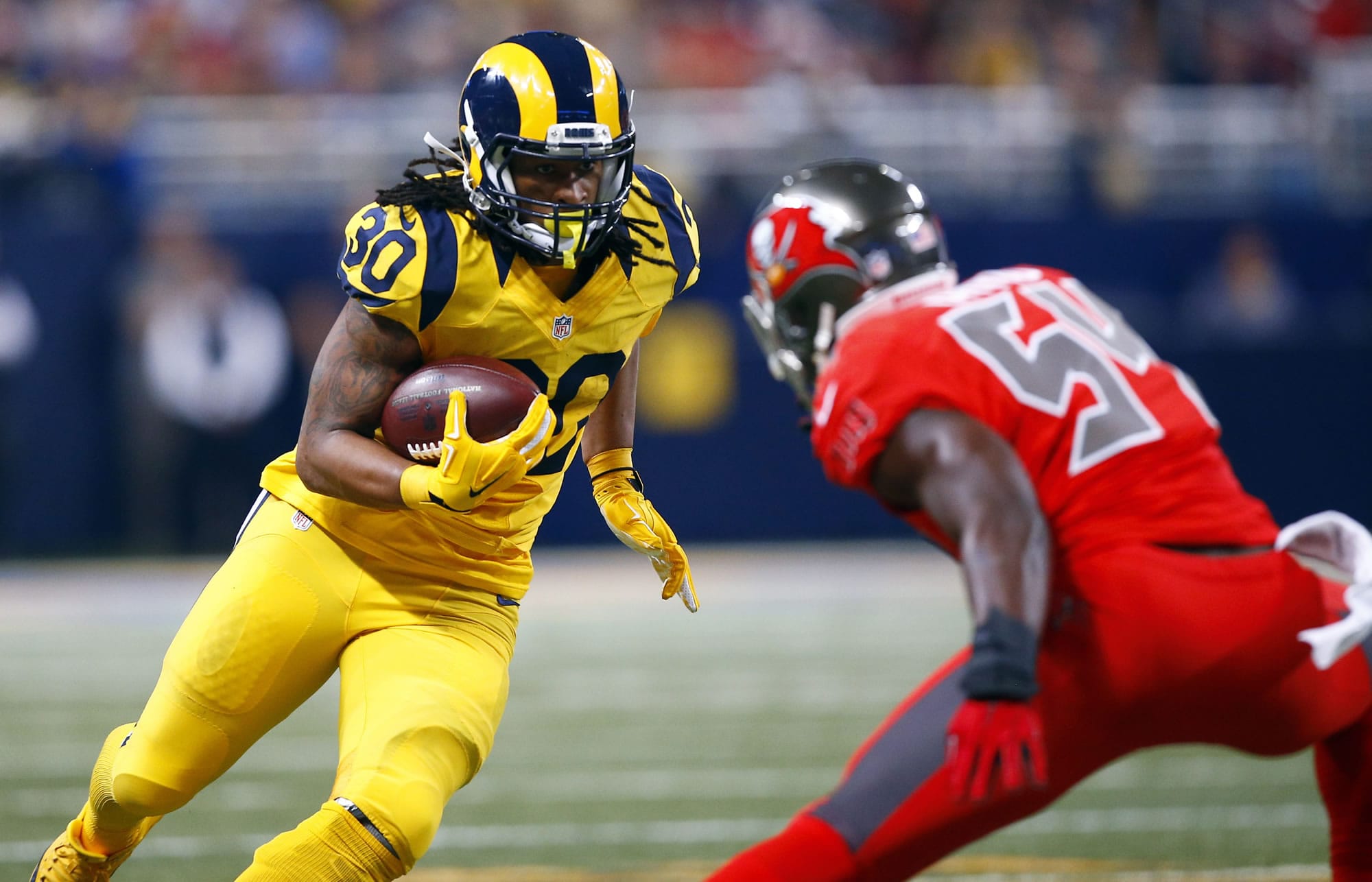 St. Louis Rams running back Todd Gurley, left, carries the ball as Tampa Bay Buccaneers outside linebacker Lavonte David defends during the second quarter of an NFL football game Thursday, Dec. 17, 2015, in St. Louis.