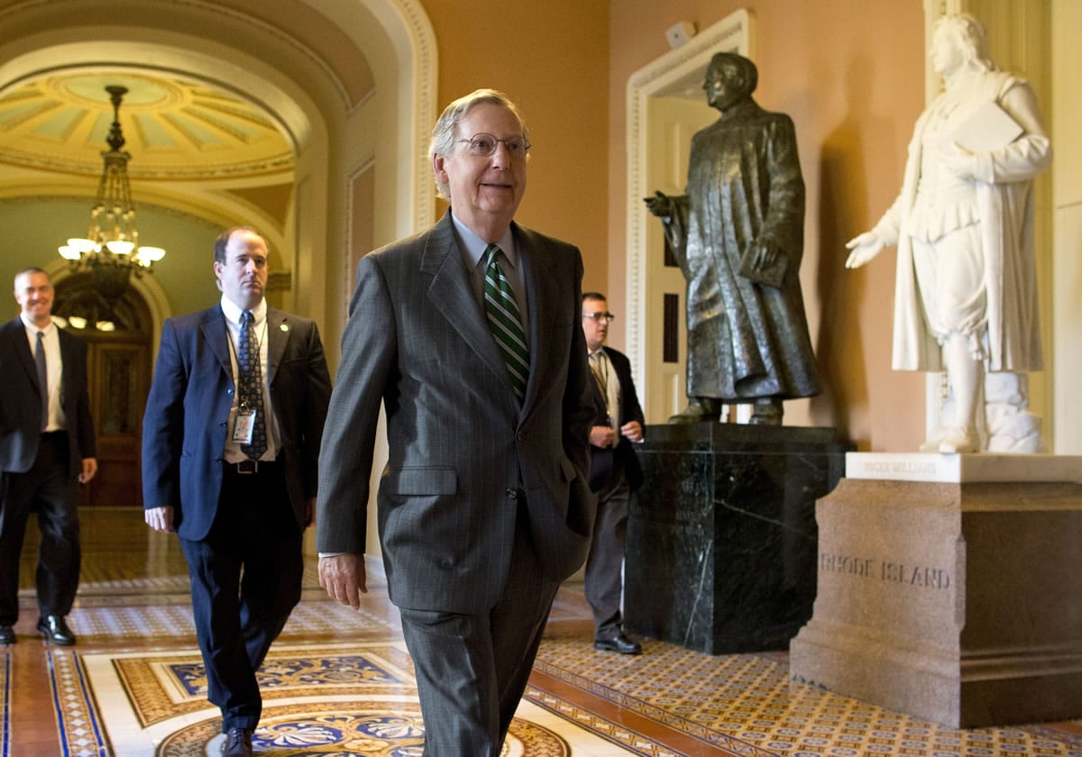 Senate Minority Leader Sen. Mitch McConnell, R-Ken., walks to his office after arriving on Capitol Hill on Monday in Washington. The federal government remains partially shut down and faces a first-ever default between Oct.