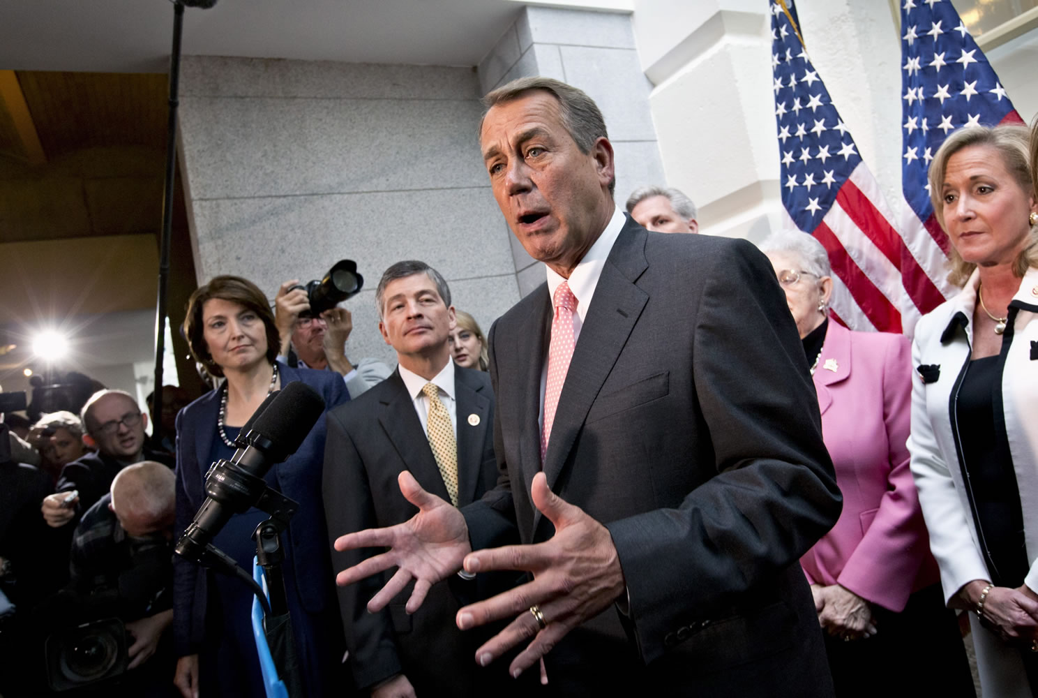 House Speaker John Boehner of Ohio, joined by fellow Republicans, speaks during a news conference on Capitol Hill in Washington on Thursday, following a closed-door GOP meeting, to announce that House Republicans will advance legislation to temporarily extend the government's ability to borrow money to meet its financial obligations.