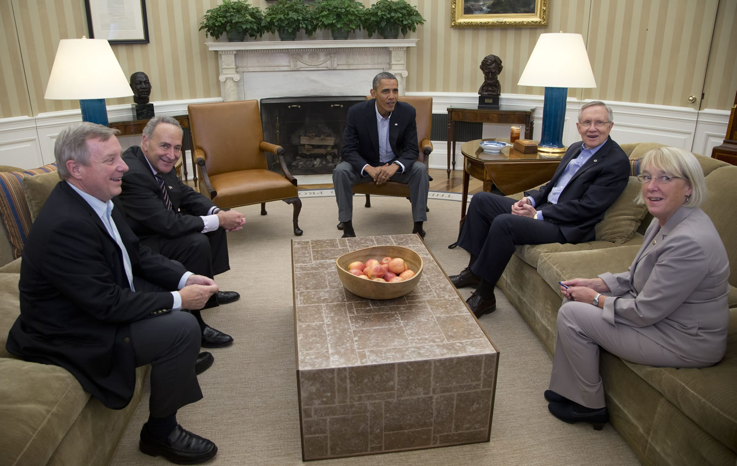 From left, Sen. Dick Durbin, D-Ill., Sen. Charles Schumer, D-N.Y., President Barack Obama, Senate Majority Leader Harry Reid of Nev., Sen. Patty Murray, D-Wash., look to photographers as they meet in the Oval Office of the White House, on Saturda in Washington. The federal government remains partially shut down and faces a first-ever default between Oct.