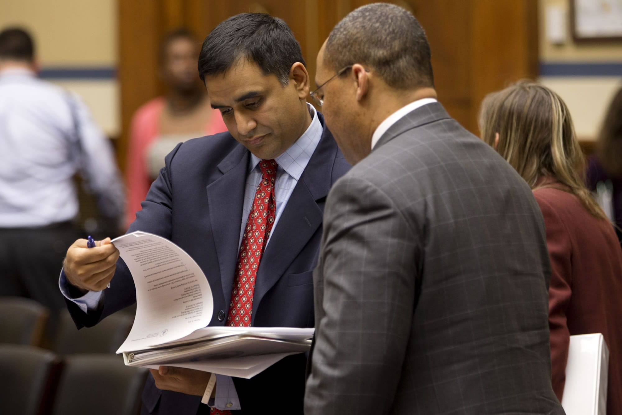 Deputy Commerce Secretary for Resource Management Hari Sastry, left, looks over documents on Capitol Hill in Washington on Tuesday during a break in his testimony in a joint hearing on sequestration held by House Oversight and Government Reform Committee's subcommittee on Economic Growth, Job Creation and Regulatory Affairs, and the subcommittee on Federal Workforce, U.S.