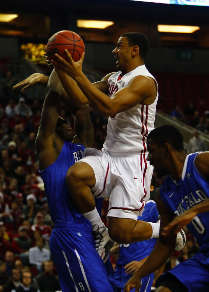 Washington State's DaVonte Lacy goes to the basket by two Buffalo players at KeyArena in Seattle on Friday night.
