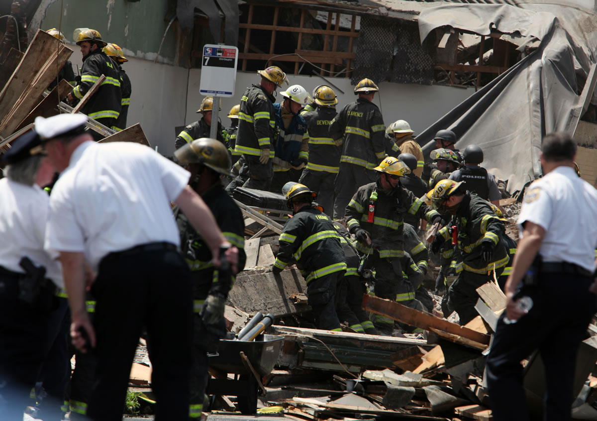 Rescue personnel search the scene of a building collapse in downtown Philadelphia on Wednesday.