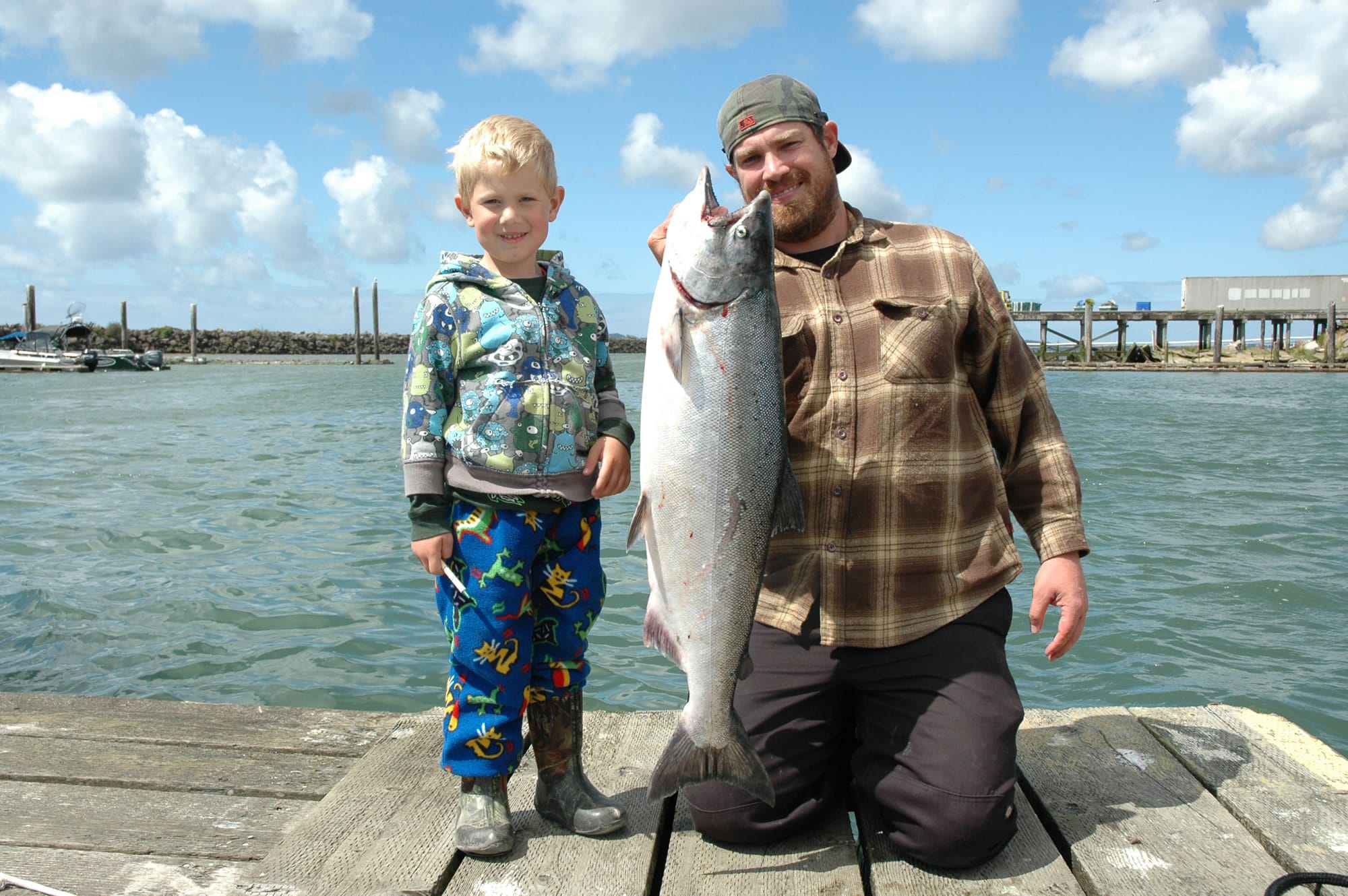 Matix Pardue poses with his dad, Eli, and a fall chinook salmon caught in the Buoy 10 fishery at the mouth of the Columbia River in 2012.