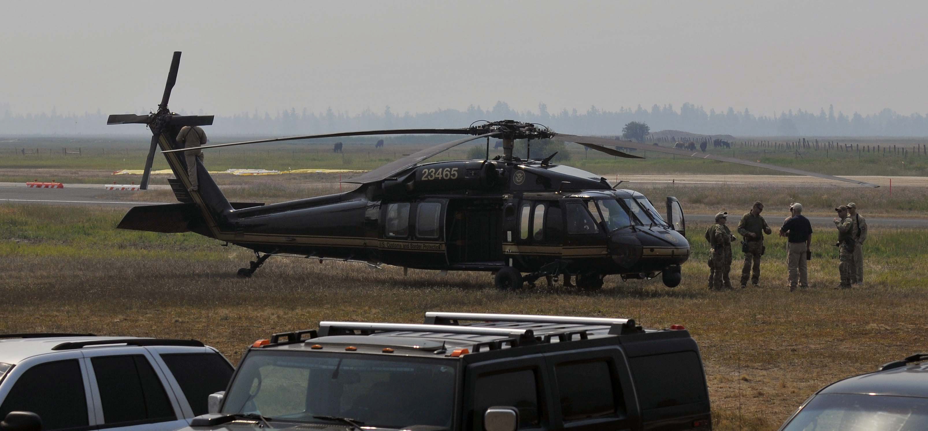 Authorities wait near a blackhawk helicopter at the Cascade Airport in Cascade, Idaho on Saturday. 40-year-old James Lee DiMaggio was suspected of kidnapping 16-year-old Hannah Anderson.